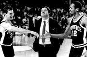 Providence coach Rick Pitino, center, stands between players Billy Donovan, left, and Delray Brooks as they congratulate each other after a Sweet 16 victory March 19, 1987. Pitino, now coach at Louisville, and Donovan, coach at Florida, plan to attend the reunion of the 1987 Providence Final Four team.