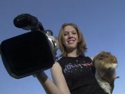 Alyssa Buecker poses with a guinea pig in this 2002 file photo. Buecker, who was home-schooled, gained national attention for her movies about guinea pigs.