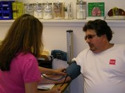 Health Care Access Clinic 11am - Manuela Ertmer, LPN takes patient Vince Bulgarelli's blood pressure during his visit to the Clinic.