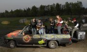 The five-member rock band The Global Warmers has chopped the top off of a 1991 Chevy Suburban that they will perform in Saturday during the Art Tougeau Parade. Inside the vehicle, from left, are Melia Clark, Kelly Howell, Harold Brandt, Joe Osborn and Rick Puhl.