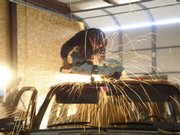 It took Kelly Howell two solid hours of cutting with a gas-powered chop saw to sever the top off this 1991 Chevy Suburban. His band, The Global Warmers, will perform live in the back of the moving vehicle on Saturday during the Art Tougeau Parade.