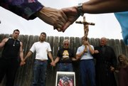 Abortion opponents pray during the first day of Operation Rescue's 77-hour "Pray In May" prayer vigil Thursday at Women's Health Care Services, a clinic operated by physician George Tiller in Wichita.