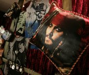 The likeness of actor Johnny Depp appears on a pillow among "Pirates of the Caribbean: At World's End" merchandise displayed in Beverly Hills, Calif. The third chapter of the blockbuster film franchise is set to hit theaters Friday.