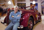 Jay Leno, host of "The Tonight Show," collects rare and fast cars - including this antique fire truck - as a hobby. Leno is marking his 15th year as host of the show tonight.