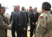 Iraqi Prime Minister Nouri al-Maliki, fourth from left, and U.S. Ambassador Ryan Crocker, third from right, greet local officials at al-Asad air base, near the city of Hit, Anbar province, about 85 miles west of Baghdad on Saturday.