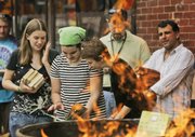Book store customers buy up books that are set to be burned at Prospero's Books in Kansas City, Mo. Bookstore owner Tom Wayne staged a book-burning Sunday to bring attention to society's diminishing demand for books and other printed materials.