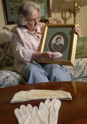 When Virginia Harris, Lawrence, puts on the white gloves, hat and dress of the American Gold Star Mothers, an organization of mothers who have lost sons or daughters in military service, her hope is to help other families who have similarly suffered. Harris, one of two Lawrence women who are members of Gold Star Mothers, is pictured at her home with a photo of her son Tim, who died in the Army during a training accident in 1986 in Germany. He is buried at Fort Leavenworth, where Harris will participate today in Memorial Day services.