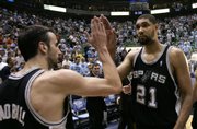 SAN ANTONIO FORWARD TIM DUNCAN (21) high fives teammate Manu Ginobili following the Spurs' victory against Utah in Game 4 of the Western Conference finals. San Antonio took a 3-1 series lead with Monday's win, and will look to close out the Jazz tonight.