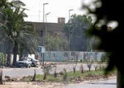 A man walks outside an Iraqi Finance Ministry office in Baghdad, after three British citizens were kidnapped. The Britons were kidnapped Tuesday by a group of gunmen wearing police commando uniforms who arrived at the ministry office in a huge convoy of white sport utility vehicles, which are often used by police, according to a government official and a police officer.