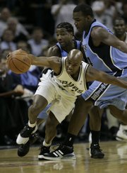 San Antonio's Jacque Vaughn, front, reaches to take control of the bgall in front of Utah's Dee Brown and Paul Millsap, right. Vaughn, a Kansas University product, had eight points and six assists, and the Spurs defeated the Jazz, 109-84, on Wednesday night in San Antonio to earn a berth in the NBA finals.