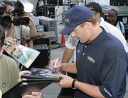 Roger Clemens signs autographs for Yankees fans who gathered to watch a telecast of the Yankees-Blue Jays game. The gathering was Wednesday in New York's Bryant Park.