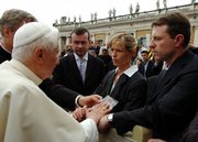 Pope Benedict XVI blesses a photograph of missing 4-year-old Madeleine McCann as her parents, Kate and Gerry, right, touch his hands during his weekly general audience in St. Peter's Square at the Vatican. The pope spoke a few words with the parents, and blessed them and the photograph as he greeted visitors in the front row during his audience. Madeleine went missing on May 3 while vacationing with her family in Portugal.