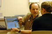 Dr. Steven Bruner of Lawrence Family Medicine & Obstetrics explains to a patient in his office that some people have trouble self-diagnosing using the Internet.