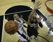 San Antonio Spurs guard Tony Parker (9) shoots over Cleveland Cavaliers forward Drew Gooden, right, in the first half of Game 1. The Spurs won the NBA finals opening game, 85-76, Thursday in San Antonio.