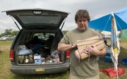 Mike Milhon, of Wichita, packs up to head home on last day of the Wakarusa Music and Camping Festival at Clinton Lake on Sunday.