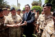 Chancellor Gordon Brown, Britain&squot;s next prime minister, meets British troops in Baghdad during a visit to the region. Brown flew into Baghdad on Monday and pledged to "learn the lessons" of events in the run-up to the conflict. Brown hasn&squot;t outlined what his specific policies on Iraq will be, though he has indicated that he wants to devote more time and resources toward the creation of jobs and basic services.