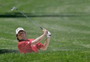 Tim Clark of South Africa watches his chip shot out of a bunker on the first fairway during the second round of the U.S. Open. Hazards and course conditions played a big part in bloated scores Friday at Oakmont Country Club in Oakmont, Pa.