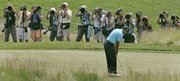 Tiger Woods putts on the fifth green during the U.S. Open. Woods trails leader Aaron Baddeley by two strokes after Saturday's third round at Oakmont Country Club in Oakmont, Pa.