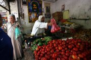 Iraqis shop at a market Sunday in central Baghdad. The Iraqi capital sprang to life Sunday after a four-day curfew to thwart violence after a provocative attack on a Shiite shrine in Samarra last week.