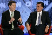 Republican presidential hopefuls Sen. Sam Brownback, R-Kan., left, and former Massachusetts Gov. Mitt Romney take part in a political debate in Manchester, N.H., in this June 5 file photo. A campaign aide for Brownback has been reprimanded for sending derogatory e-mails concerning Romney's Mormon faith.