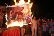 Hamas supporters burn a poster of Palestinian President Mahmoud Abbas and U.S. Secretary of State Condoleezza Rice during a protest against a speech made by Abbas condemning Hamas. The protesters were in the Jebaliya refugee camp in the northern Gaza Strip.