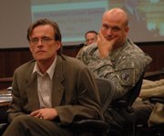 Bart Dean, left, an associate professor of anthropology at Kansas University, and Lt. Charles Bartles listen to an audience member's comment during the "military-social science roundtable" Thursday at Fort Leavenworth.