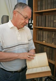 Paul Bahnmaier looks through a book collection Wednesday in the Territorial Capitol Museum in Lecompton. A document that once put this small town at the center of a roiling national debate will be 150 years old this year, adding a little more luster to a summer celebration of Kansas' territorial days. That document - a proposed state constitution drafted in Lecompton in the fall of 1857 - would have admitted Kansas to the Union as a slave state.