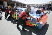 Jeff Gordon's crew pulls Gordon's car from the garage area before a practice run. Gordon's car failed initial inspection Friday in Sonoma, Calif.