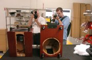 MartinLogan Club members John Burke, left, of Chicago, and Ben Milne, Des Moines, Iowa, focus on some of the company's components during a tour of the company's campus in East Lawrence. About 25 club members finished their first National Get-Together by visiting the complex Monday.