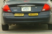 Cars used by students in the driver's education program carry specific signs to identify young learners to other drivers on the road.