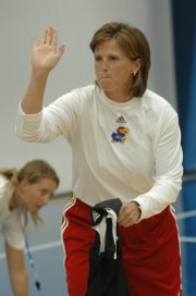 Kansas women's basketball coach Bonnie Henrickson high-fives a participant in Tuesday's camp at Horejsi Center.