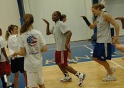 Kansas University basketball players Danielle McCray, center, and Rebecca Feickert, right, perform a dance routine along with campers at the Bonnie Henrickson Individual Basketball Camp. The camp was Tuesday at Horejsi Center.