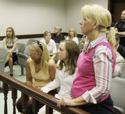 Patricia Porter, Jessie Davis' mother, right, stands and stares at Bobby Cutts Jr., unseen, in a courtroom in Canton, Ohio. Cutts, accused of murdering his pregnant girlfriend, Jessie Davis, and her nearly full-term fetus, was expressionless when a judge ordered him held on $5 million bond. Seated next to Porter is Whitney Davis, Jessie's sister.