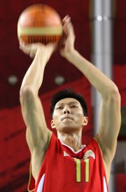 China's Yi Jianlian puts up a shot during the Asian Games in this file photo from Dec. 4, 2006, in Doha, Qatar. He'll become the NBA's fourth Chinese player, but it remains to be seen if he'll have the impact of the third, Yao Ming.