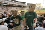 Adam Foust, left, and Tim Tomayko, right, of South Buffalo, N.Y., and Kris Kramer, center rear, of Sarver, Pa., participate in a walk out after the third inning of the Pirates' game against Washington. A small group of fans walked out of the game Saturday in Pittsburgh to protest the team's 15 years of futility.