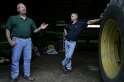 Roger Burtchin, 60, left, is seen with his son, Kevin, at Roger's farm near Pemberville, Ohio. Burtchin, a retired teacher, said he expects that one day his son, Kevin, will take over the farm. His son works as a civil engineer and raises hormone-free cattle in his spare time.