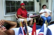 Ralph, center, and Ermie Gauna talk with Sam Pacheco, foreground, and their family Wednesday during the Pacheco family reunion in Lawrence. The family has a long tradition of military service, including a Marine who might be deployed to Iraq. Ralph Gauna and Sam Pacheco served in the Marines and Army, respectively.
