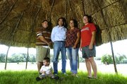 Haskell Indian Nations University professor Dan Wildcat, second from left, is shown with Haskell student Chahta Butler, left, alumna Katrina McClure, second from right, and student Tara Hammer. All helped make or repair the Caddoan arbor at the university. Wildcat will give a four-minute televised speech about the environment Saturday morning.