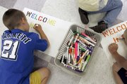 Several young boys work on welcome home signs for their fathers June 27 at Camp Noah in Baxter, Minn. The camp is a free program for children with parents serving in the National Guard and offers an opportunity for them to share their cares.