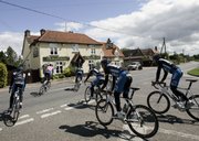The Discovery Channel team rides in the countryside during a training session prior to the 94th edition of the Tour de France. The race starts today in London.