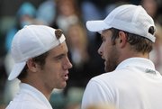 Richard Gasquet, left, greets Andy Roddick after beating him in a quarterfinal match. Gasquet won in five sets Friday at Wimbledon, England.