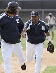 Detroit infielder Neifi Perez, right, chases down Magglio Ordonez during a spring-training workout. Perez was suspended 25 games by Major League Baseball on Friday for testing positive for a banned stimulant.