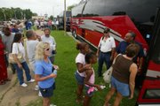 Coffeyville residents displaced by the recent flood await their turn to board buses for a tour of the restricted area Monday.