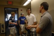 Mark Rigby, Marion, Iowa, freshman, second from right, talks with Kappa Sigma member and Paola junior Mike Thompson, right, as Overland Park freshman Jared Lindsay, left, gets a tour of the house from fraternity member and Prairie Village sophomore Derek Hoefer during a recent visit to the fraternity.