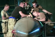 U.S. airmen from the 332nd Expeditionary Aircraft Maintenance Squadron repair a F-16 Falcon on June 21 at Balad Air Base, 50 miles north of Baghdad. The Air Force has been quietly building its Iraq presence during the "surge" in U.S. ground troops.