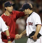 Boston Red Sox pitcher Josh Beckett, left, congratulates rookie Kason Gabbard after his complete-game, 4-0 victory over the Kansas City Royals. Gabbard blanked the Royals Monday in Boston.
