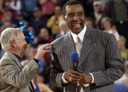 Former Kansas University basketball standout Jo Jo White, right, yuks it up with radioman Max Falkenstien during White's jersey-retirement ceremony in this file photo from 2003. Though he works for the Boston Celtics, White says he keeps close tabs on the Jayhawks.