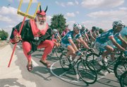 Didi Senft, of Germany, also known as "El Diablo," reacts as the pack passes the outskirts of Angouleme during Friday&squot;s 18th stage of the 94th Tour de France.