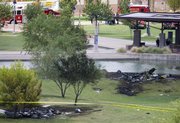 The wreckage of two news helicopters that collided over Phoenix are shown Friday. Two news helicopters covering a police chase on live television collided and crashed to the ground Friday, killing all four people onboard in a plunge that viewers saw as a jumble of spinning, broken images.