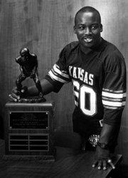 Kansas University football player Willie Pless holds the award that bears his name: KU's Willie Pless Tackler of the Year Award.